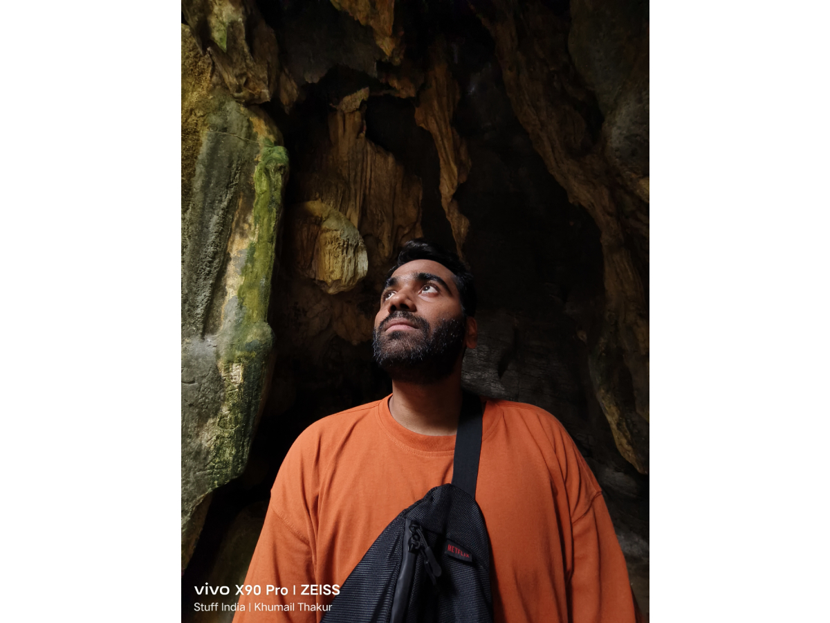 Ultrawide shot with a small peering white light through the crevices of the caves of Ninh Binh, Vietnam.